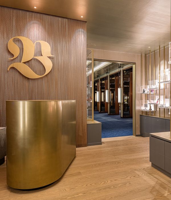 Luxury reception area with gold B logo and curved desk
