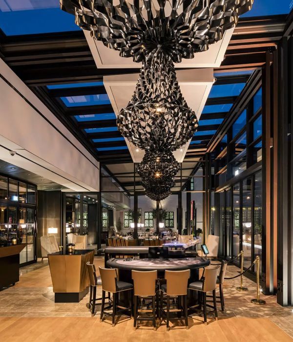 Modern restaurant interior with chandelier and round bar creating inviting atmosphere