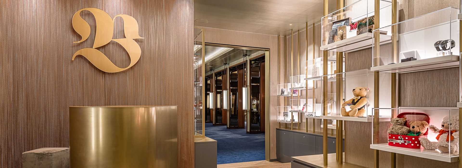 Luxury boutique interior with golden '23' logo and stylish merchandise displays