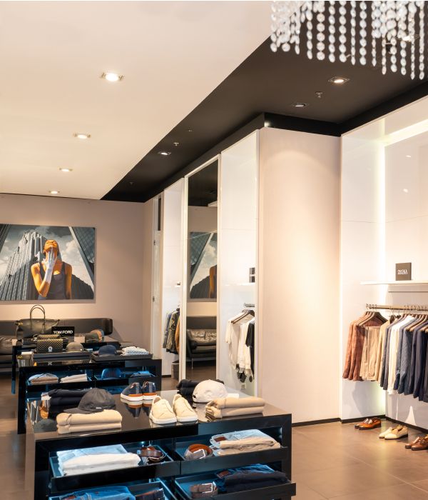 Stylish clothing store interior with 20% discount sign and modern lighting