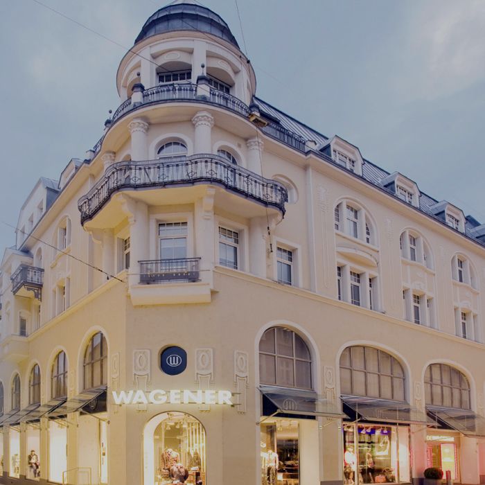 WAGENER building with balconies and large windows in evening light