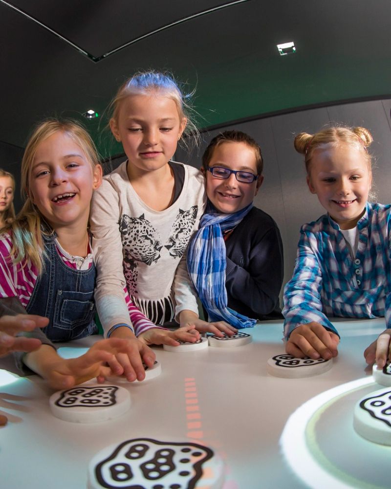 Children enjoying interactive learning with educational circular objects in classroom