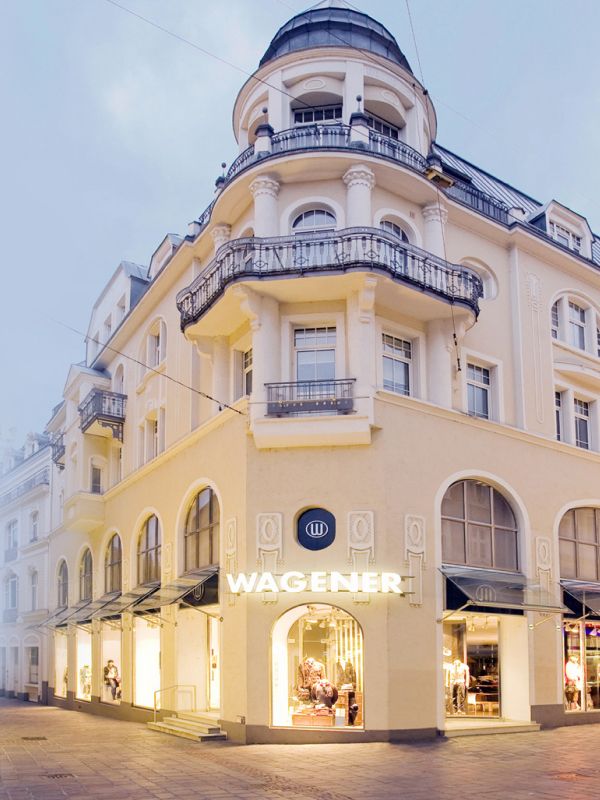 Elegant Wagener building with turret and arched windows at dusk