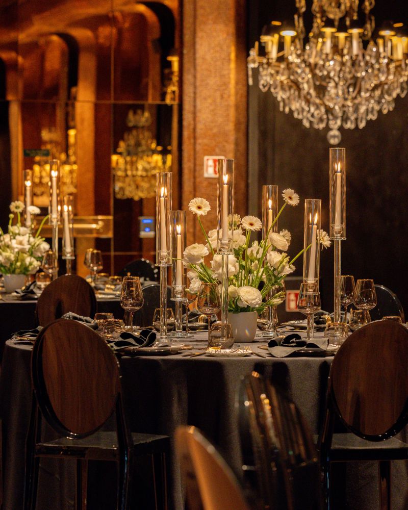 Elegant dining setup with floral centerpieces and chandelier lighting
